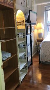 a book shelf in a room with a bed at Highland Park Pittsburgh in Pittsburgh