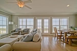 a living room with a couch and a table at Oceanview Reserve home in Holden Beach