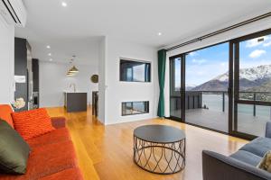 a living room with a couch and a table at Spa, Mountains & Lake in Queenstown