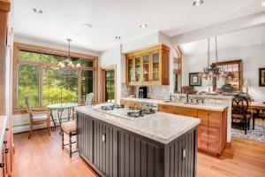 a kitchen with a large island and a dining room at 40 Goshawk home in Avon