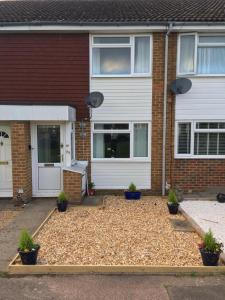 RoffeyにあるKB99 Comfy 2 Bedroom House in Horsham, pets very welcome with easy links to London and Gatwickの植物の前庭のある家