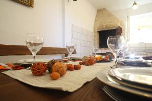 a table with wine glasses and food on it at Holiday house Poljana in Poljana