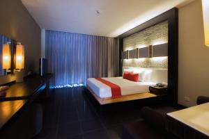 a hotel room with a bed and a large window at The Zign Hotel in Pattaya North