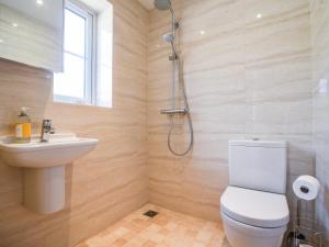 a bathroom with a shower and a toilet and a sink at Seagull Cottage in Lyme Regis +15 photos