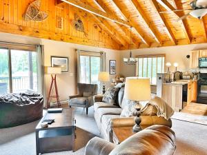 a living room with a couch and a table at Esther Mountain Chalet in Wilmington +28 photos