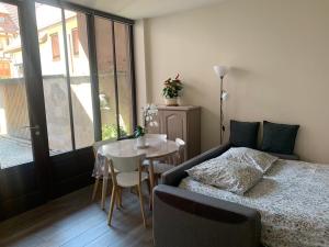 a bedroom with a bed and a table and a table and chairs at la grange à Emile in Dambach-la-Ville
