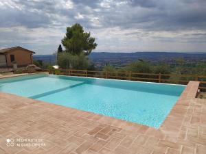 a swimming pool with a view from a house at Azienda Agrituristica Il Moraiolo in Foligno