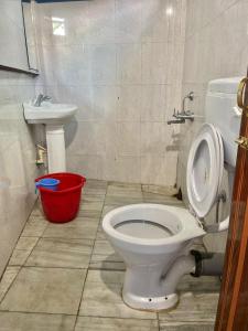 a bathroom with a toilet and a sink at Chief Guest House in Āīzawl