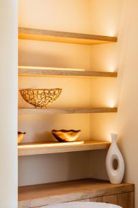 a room with wooden shelves and a white vase at Pacha Hotel in Ibiza Town