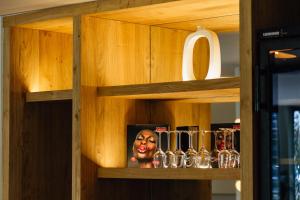 a shelf with wine glasses and a statue of a woman at Pacha Hotel in Ibiza Town