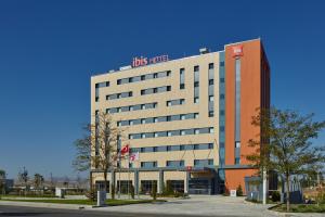 a building with a us hotel sign on top of it at ibis Ankara Airport Hotel in Ankara
