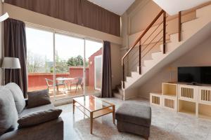 a living room with a couch and a tv at PARK SEDO Aparthotel in Rubí