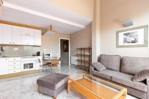 a living room with a couch and a table at PARK SEDO Aparthotel in Rubí