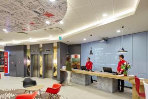 two people standing at a reception desk in an office at ibis Ankara Airport Hotel in Ankara