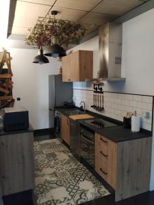 a kitchen with a sink and a stove top oven at Loft Torres Centro in Oviedo