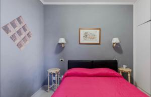 a bedroom with a bed with a pink blanket at VIA VENETO SUITE 529 in Rome