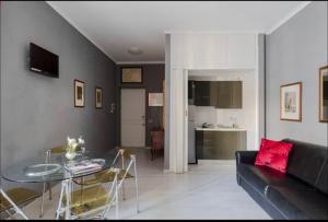 a living room with a glass table and a couch at VIA VENETO SUITE 529 in Rome