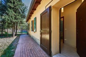 an open door of a building with a brick walkway at CARLOTTA FIERA SUITE in Bologna