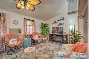 a living room with two chairs and a fireplace at Homosassa Retreat with Sunroom and Canal Views! in Homosassa