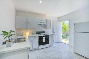 a kitchen with white appliances and a white refrigerator at Cozy Lompoc Studio with Patio about 9 Mi to Beach in Lompoc