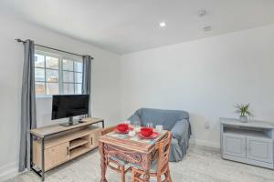 a living room with a tv and a coffee table at Cozy Lompoc Studio with Patio about 9 Mi to Beach in Lompoc