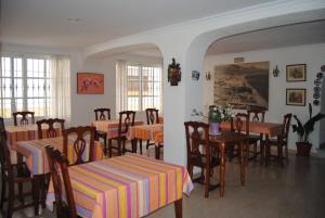a restaurant with tables and chairs in a room at Hostal Italia in Fuengirola