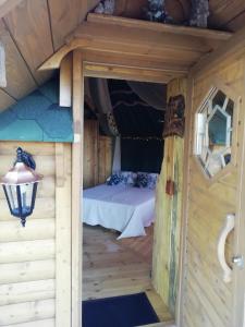 a room in a cabin with a bed in it at La Chaumière des Elfes in Servas