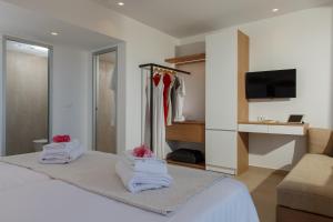 a hotel room with a bed with towels on it at Aloe Boutique Hotel Powered By Anissa in Hersonissos +34 photos