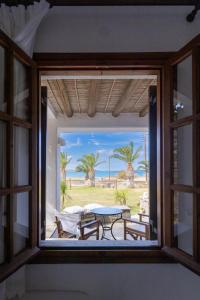 a window view of the beach from a room at Sunset Pounda in Pounda