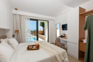 a hotel room with a bed and a bathroom at Aloe Boutique Hotel Powered By Anissa in Hersonissos