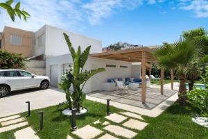a white car parked in front of a house at Villa Elora Platanias in Platanias