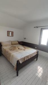 a large bed in a room with a window at Ema Apartments in Ulcinj