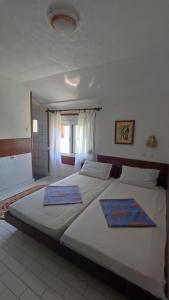 a bedroom with a large bed with two mats on it at Ema Apartments in Ulcinj