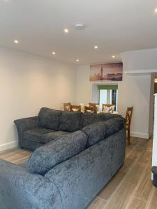 a living room with a large couch and a table at Eyre Square Lane Budget Rooms in Galway