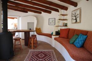 a living room with a couch and a table at Half Moon Hollow Eco Cottage in Mossel Bay