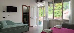 a living room with a couch and a tv at b&b L`Oasi in Casal Velino