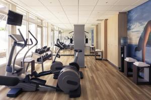 a gym with treadmills and elliptical machines at Mercure Hotel Amsterdam West in Amsterdam