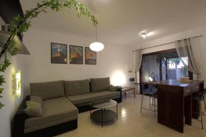 a living room with a couch and a table at BEACH FRONT GRANILLO - ocean view, garden, bright and comfortable, Wi-Fi in Costa Calma