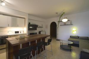 a kitchen and living room with a table and chairs at BEACH FRONT GRANILLO - ocean view, garden, bright and comfortable, Wi-Fi in Costa Calma