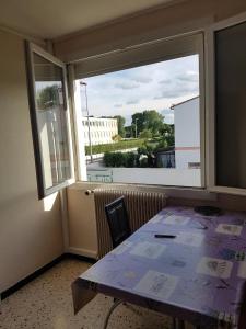 a dining room with a table and a large window at City Break in Narbonne