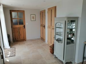a room with a glass cabinet with dishes in it at Gites Lou Limbert in Valensole