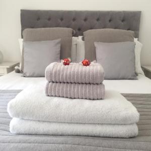 a pile of towels sitting on top of a bed at Whitstable The Jolly in Whitstable