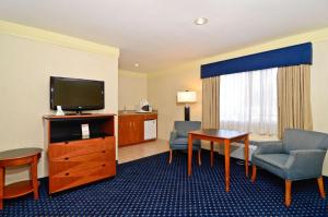 a hotel room with a television and a living room at Mission Bay Inn San Diego in San Diego