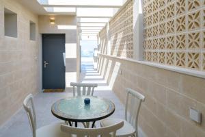 a table and chairs in the hallway of a building at PRINCES of the Dead Sea by CROWN in Neve Zohar