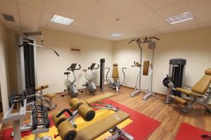 a gym with a lot of exercise equipment in a room at Hotel Cavour in Rieti