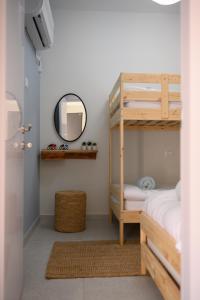 a bedroom with a bunk bed and a mirror at PRINCES of the Dead Sea by CROWN in Neve Zohar