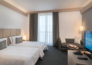 A bed or beds in a room at Domina Milano Fiera