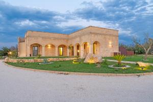 a large brick building with a garden in front of it at TENUTA DOROLIVO in Otranto