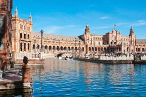 a large building with a river in front of it at Penthouse!!! Center of Seville!!! 2 BR + 2 bath!!! in Seville