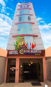 a hotel style building with a lot of flags on it at Hotel Costa Norte in Chiclayo